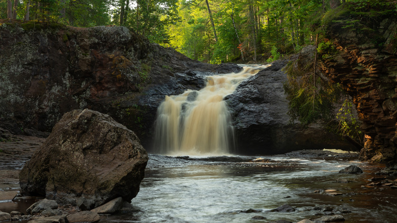 The Upper Falls waterfall flowing over rocks at Amnicon Falls State Park in Wisconsin