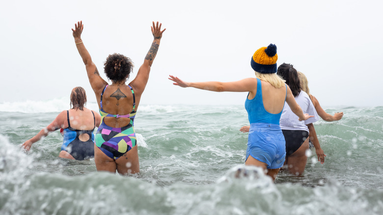 Group of friends swimming in water