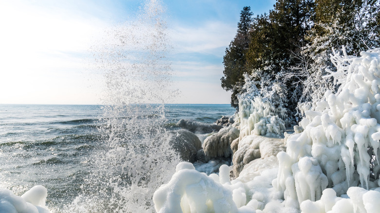 Waves crashing on an ice covered shoreline at Cave Point Park in Door County, Wisconsin