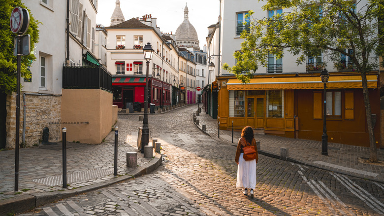 A woman walking on a street in Europe