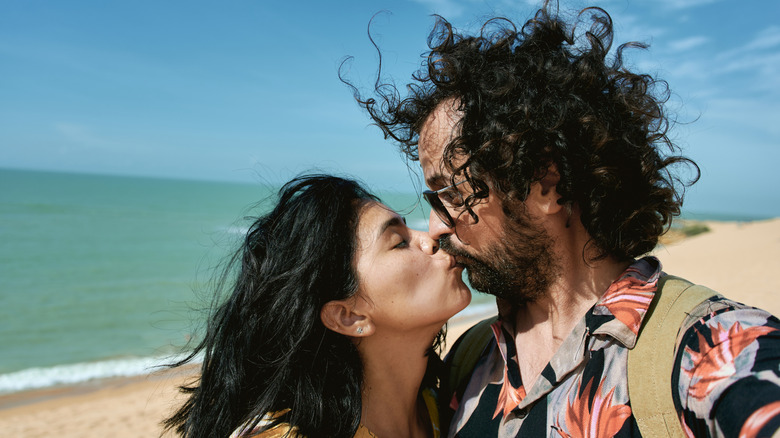 Couple taking a selfie on the beach, of Dunas Cabo de la Vela, La Guajira, Colombia