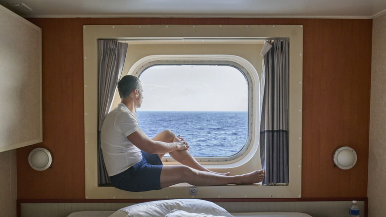 Man in his cruise cabin on the open seas
