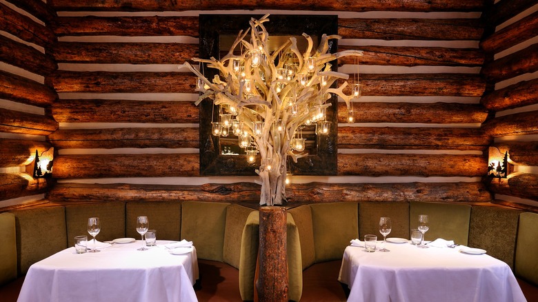 Two leather-clad booth tables at Snake River Grill with a beautiful antler "tree" fixture hung with candles