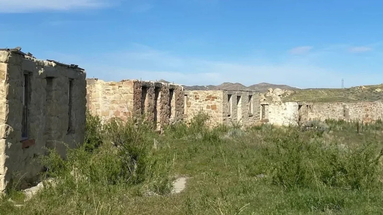 Ruins of old stone building overgrown by grass, Gebo, Wyoming