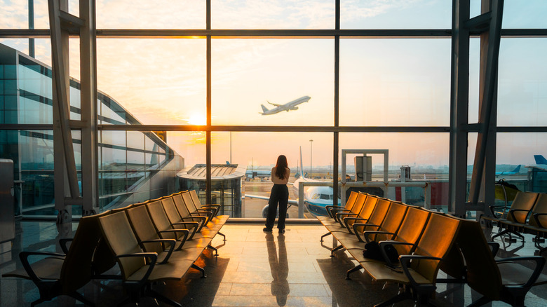 person watching plane takeoff from airport