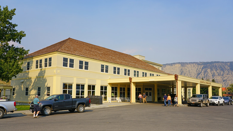 Summertime guests walk outside of the Mammoth Hot Springs Hotel in Yellowstone National Park
