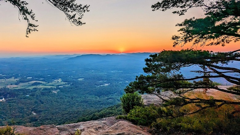 A view of a sunset and mist over silhouettes of mountains Mount Yonah Georgia
