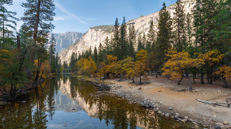 Granite cliffs of Yosemite National Park reflected in the Merced River
