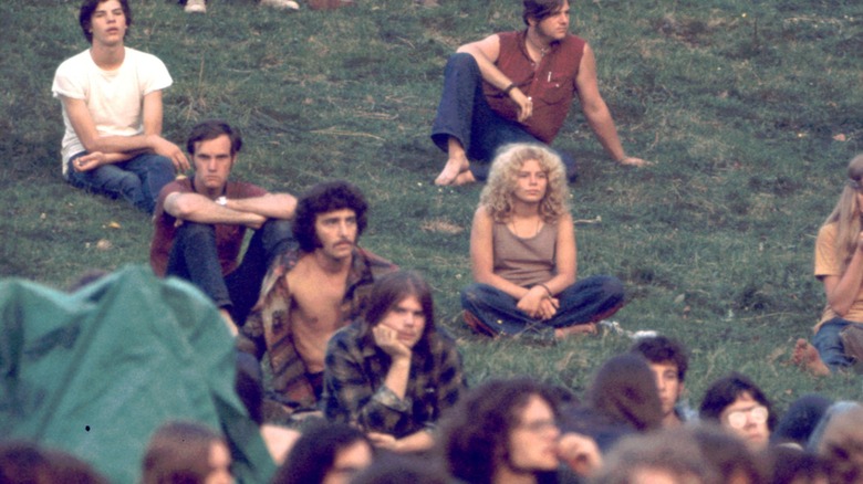 People sitting in grass at Woodstock Festival