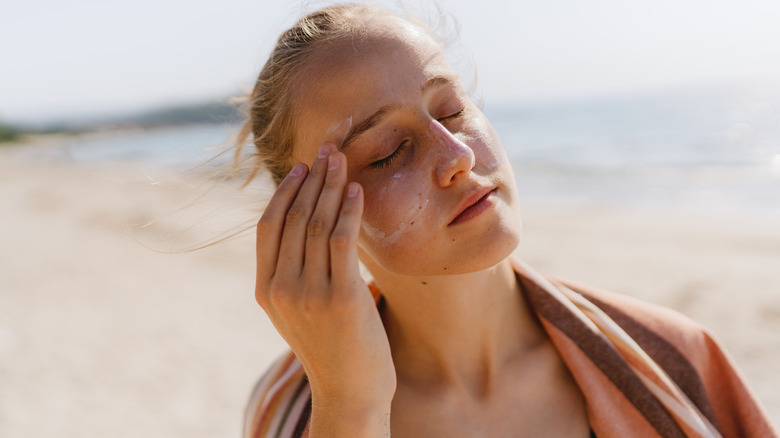 Woman putting on sunscreen