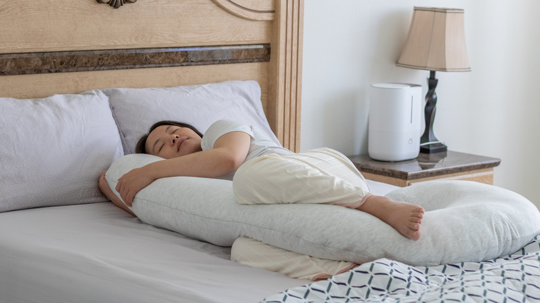 Woman with a body pillow