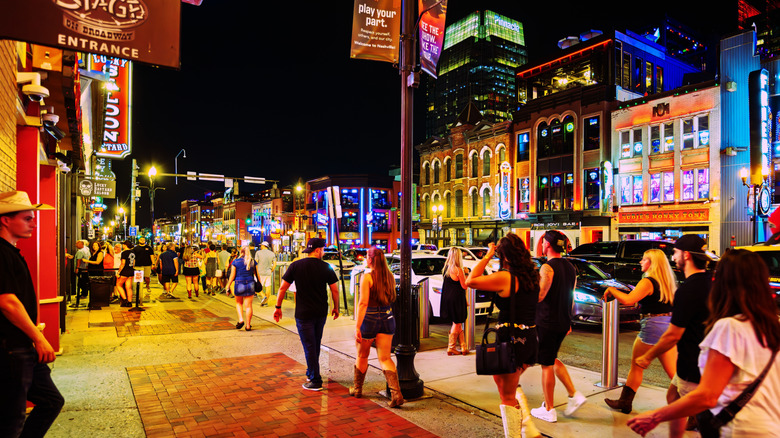 Many people on the street at night in downtown Nashville