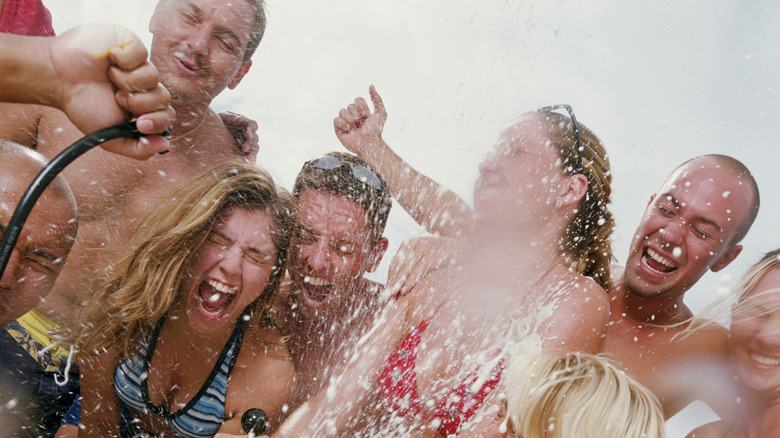 People partying and tapping a keg