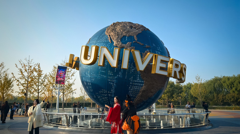 Women taking photos in front of Universal Studios Beijing globe
