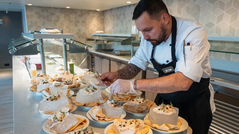 Chef preparing dishes during the Tundra to Table dining experience