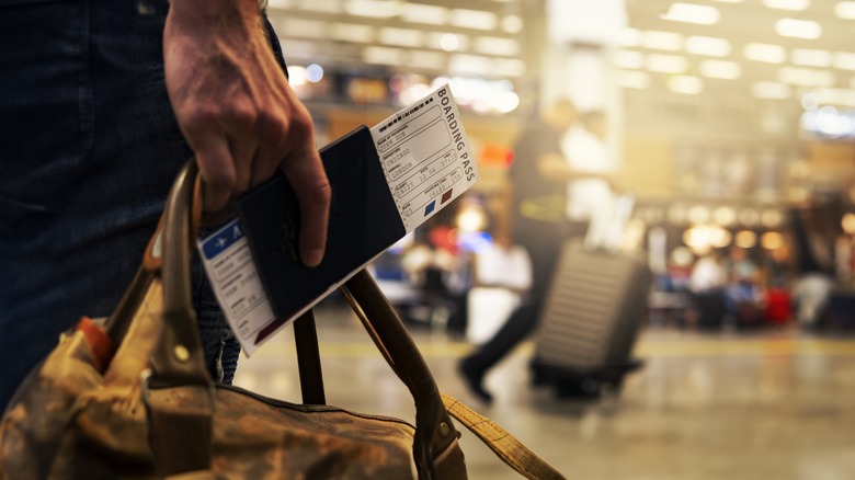 Man holding a boarding pass