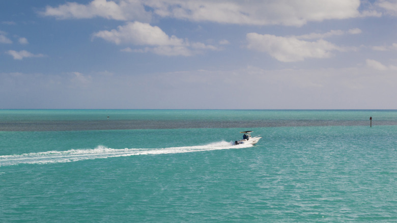 A boat riding on the ocean in Islamorada during the day