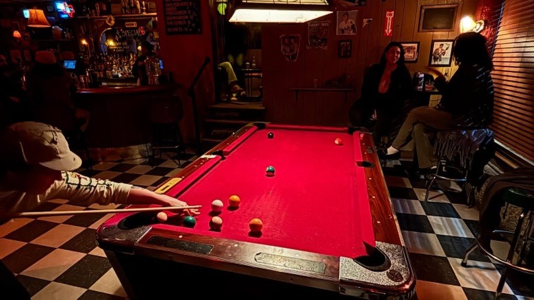 A person shooting pool at Ray's in New York City