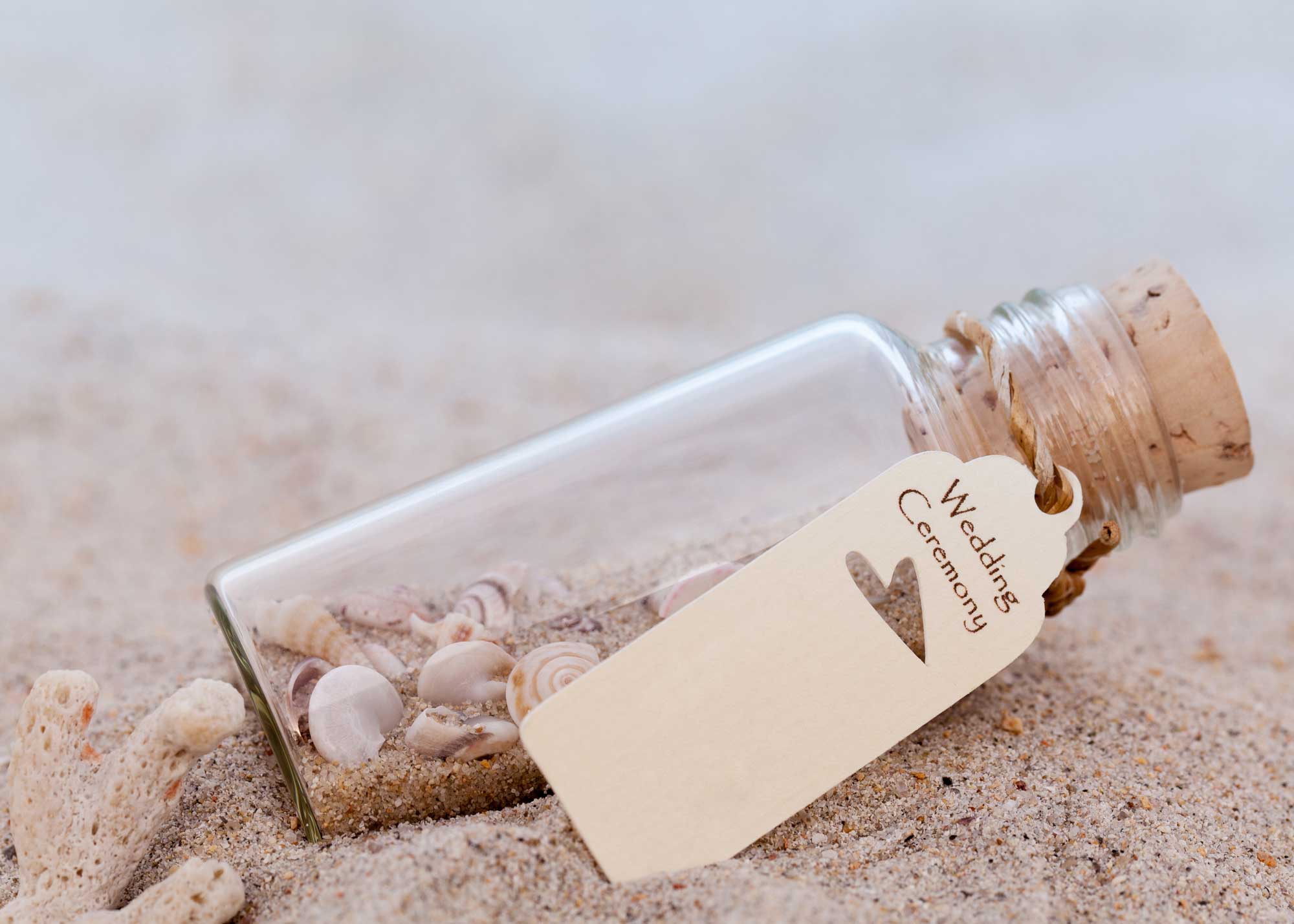 Message in a bottle lying on a sandy beach