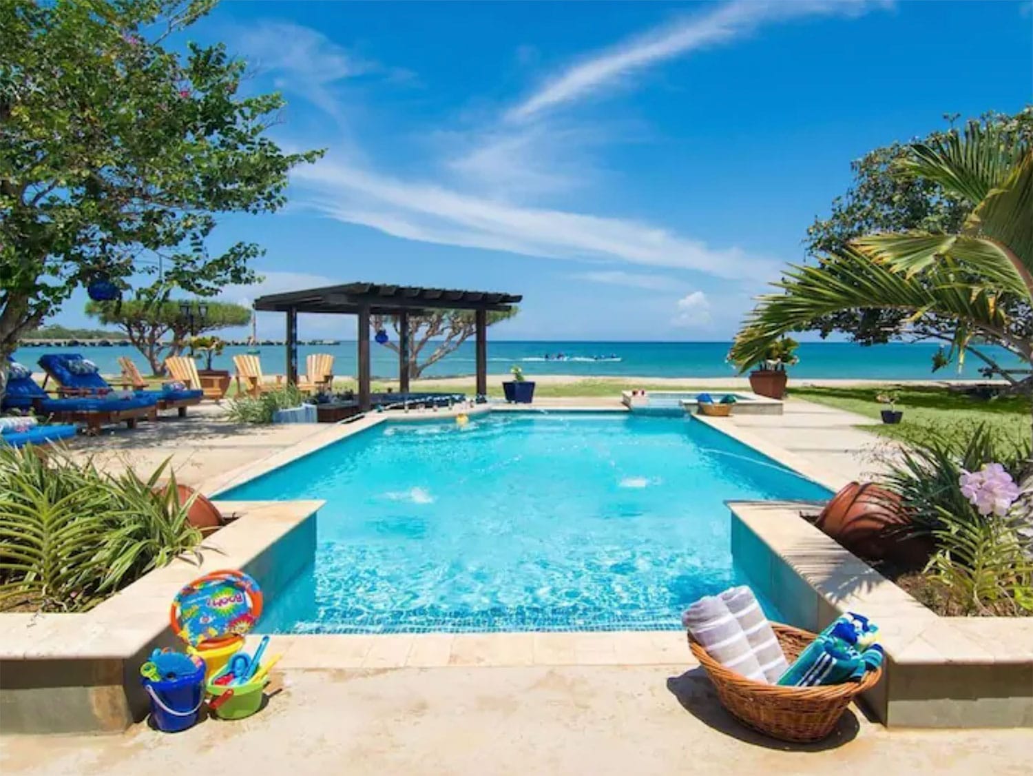 An outdoor pool next to the beach.