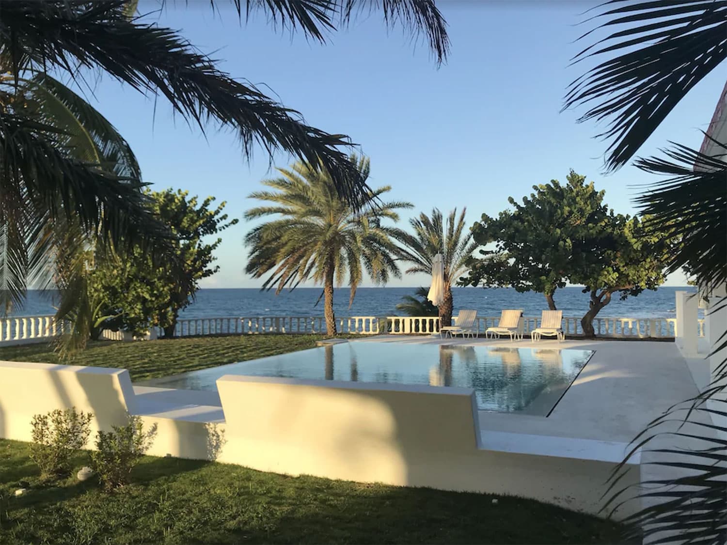 An outdoor resort-style pool and lounge area  near the beach.