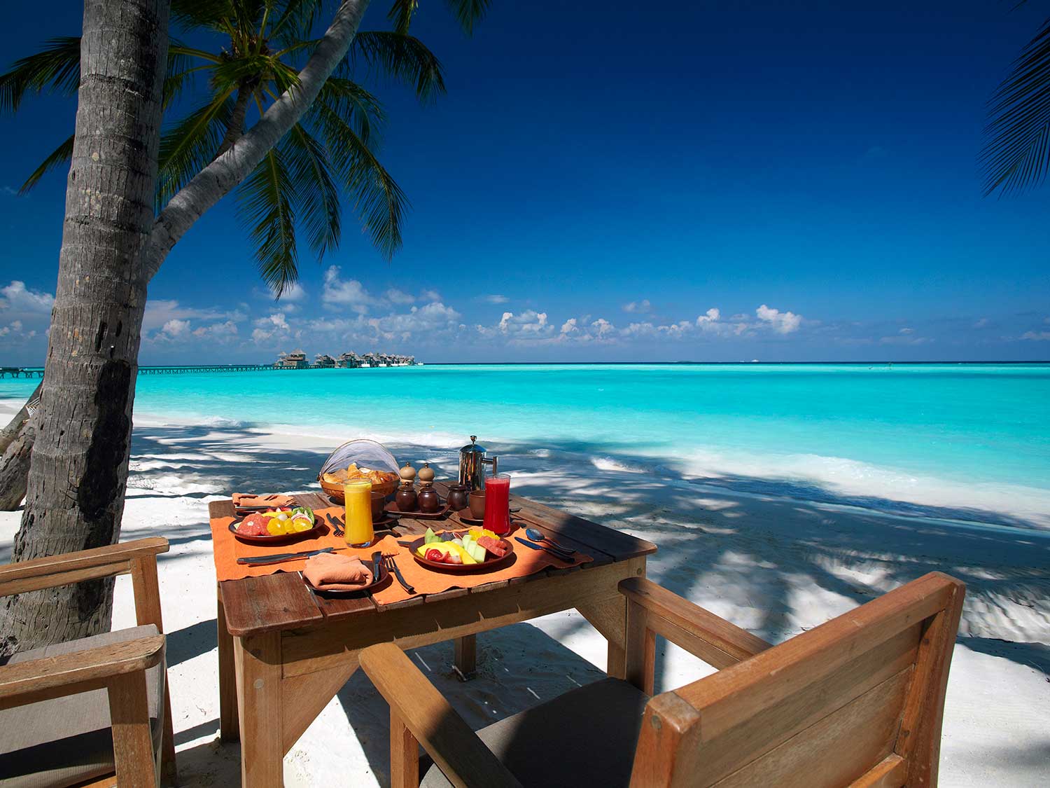 A small dining area on the beach of an island resort.