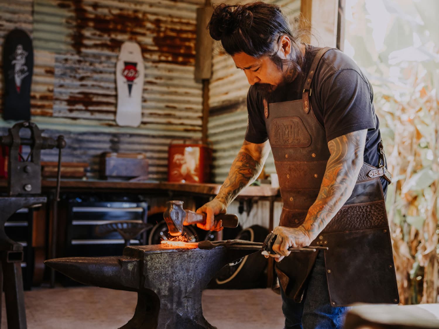 A blacksmith working over hot metal.