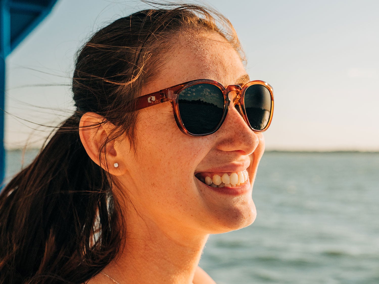 A woman smiling and wearing sunglasses.