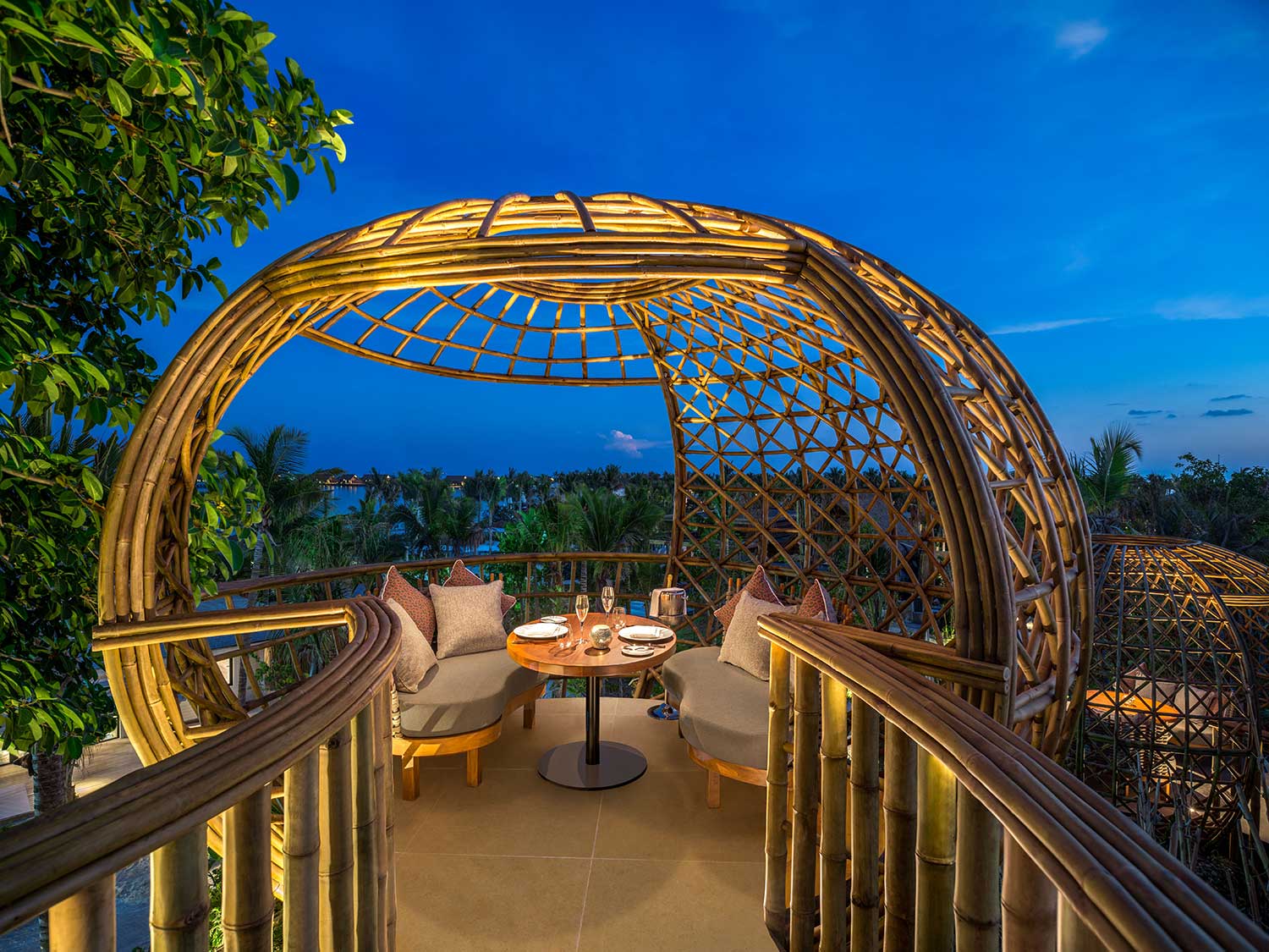 An outdoor dining area lit up at night.