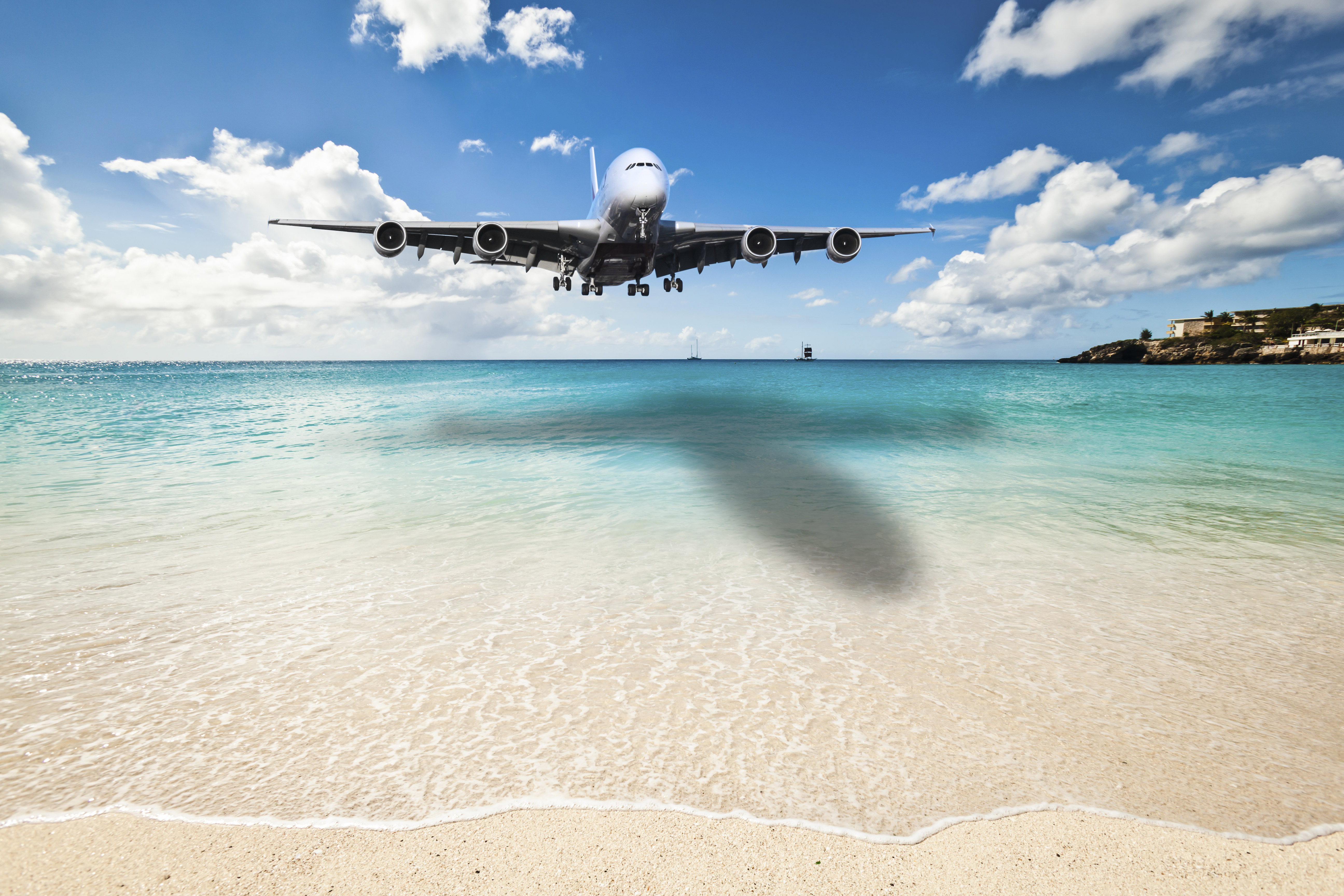 Airplane over Island beach | best Nonstop flights