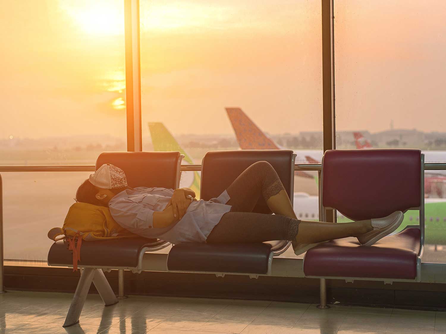 man sleeping at airport