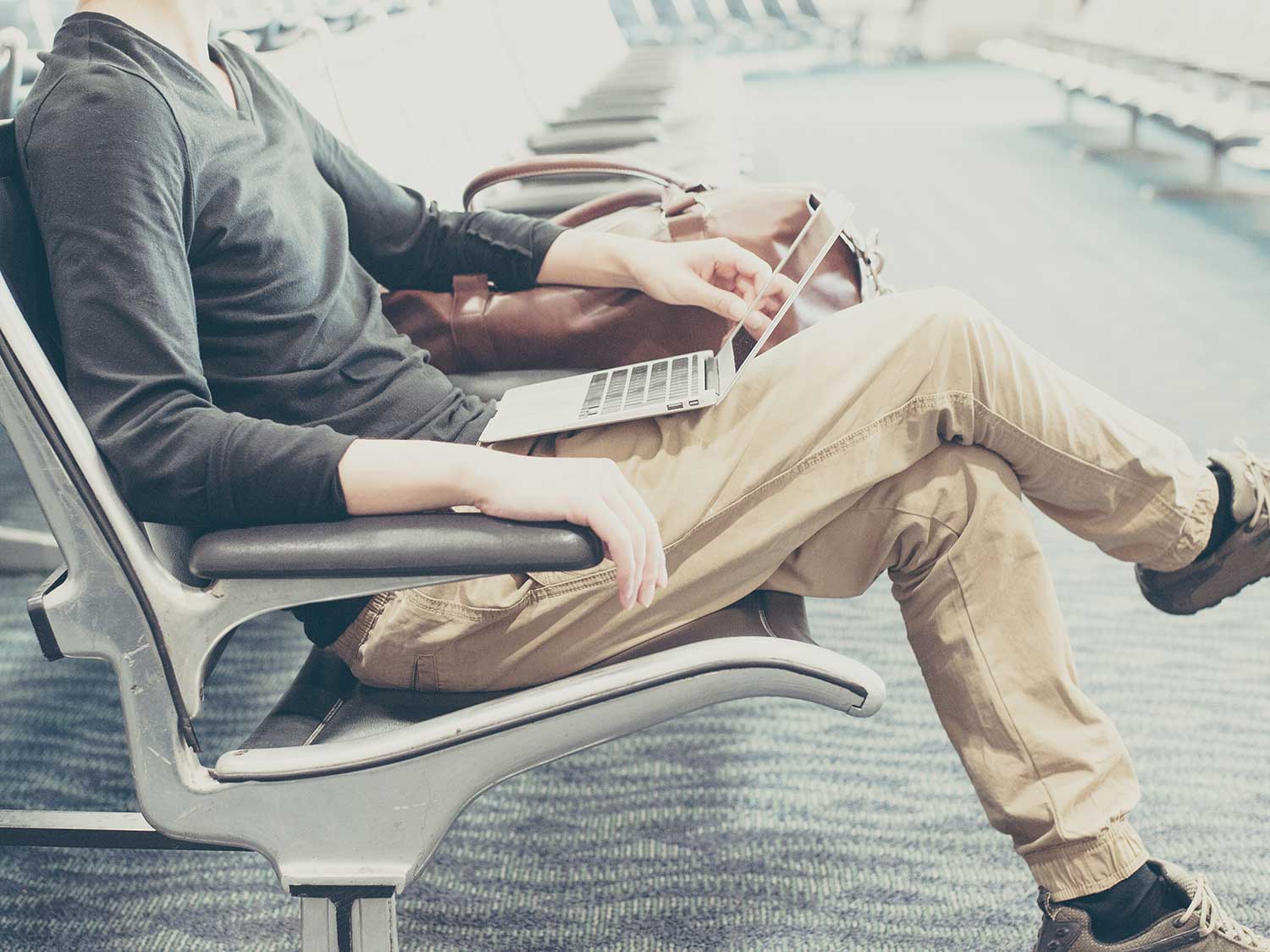 Man on laptop in airport