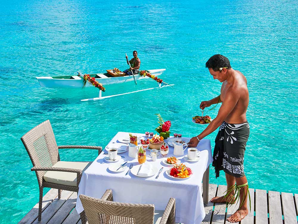 A breakfast spread delivered by outrigger canoe in Bora Bora