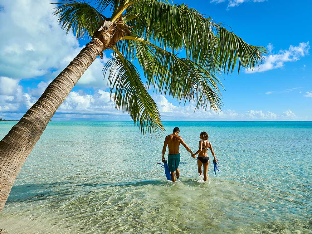 Couple in the water on the private island of Motu Tapu Bora Bora