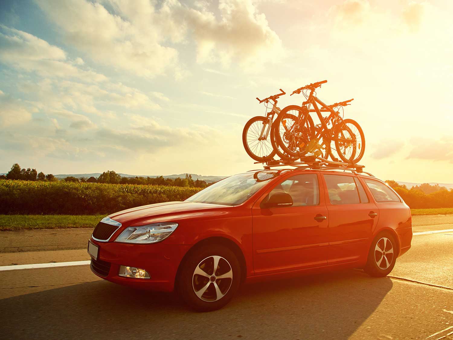 Bicycles mounted on top of car.