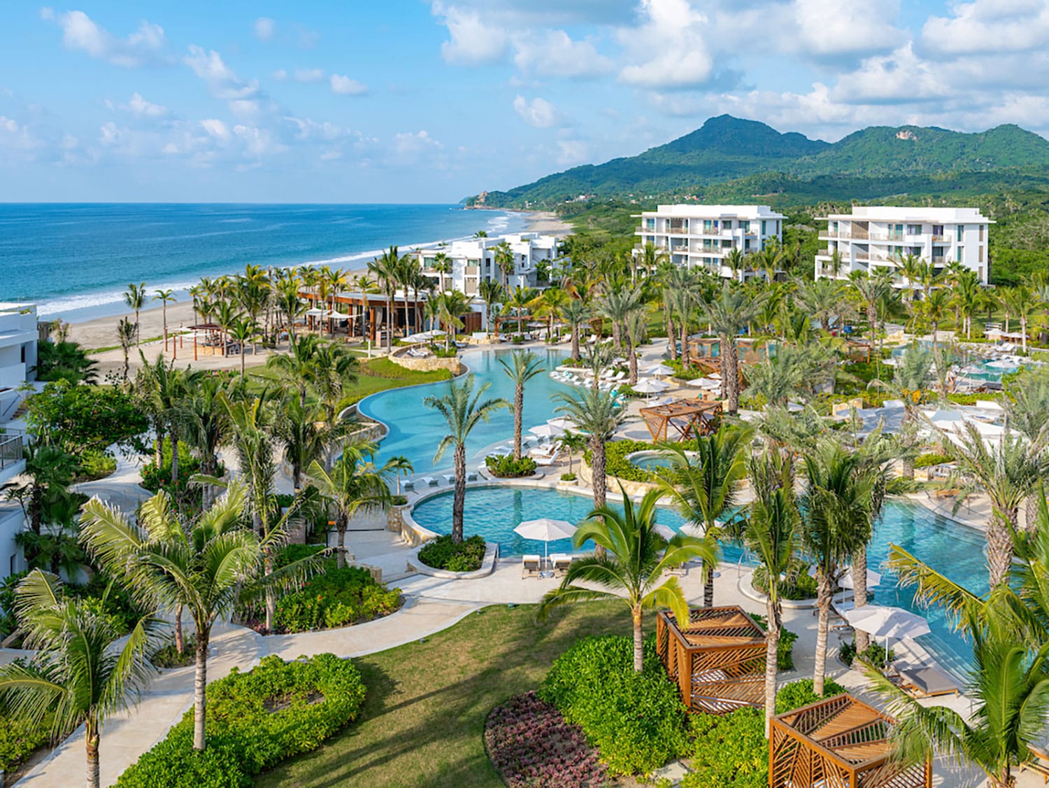 Three pools at a spa beacch resort.