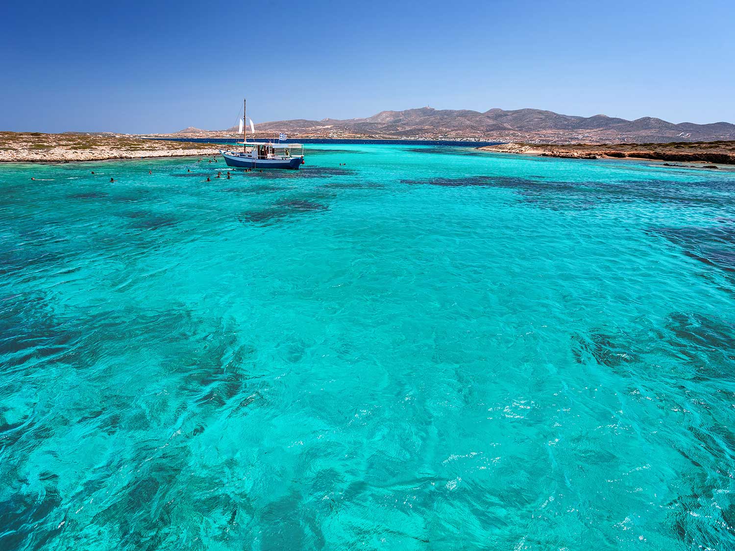 A crystal clear blue lagoon surrounded by Greek islands.