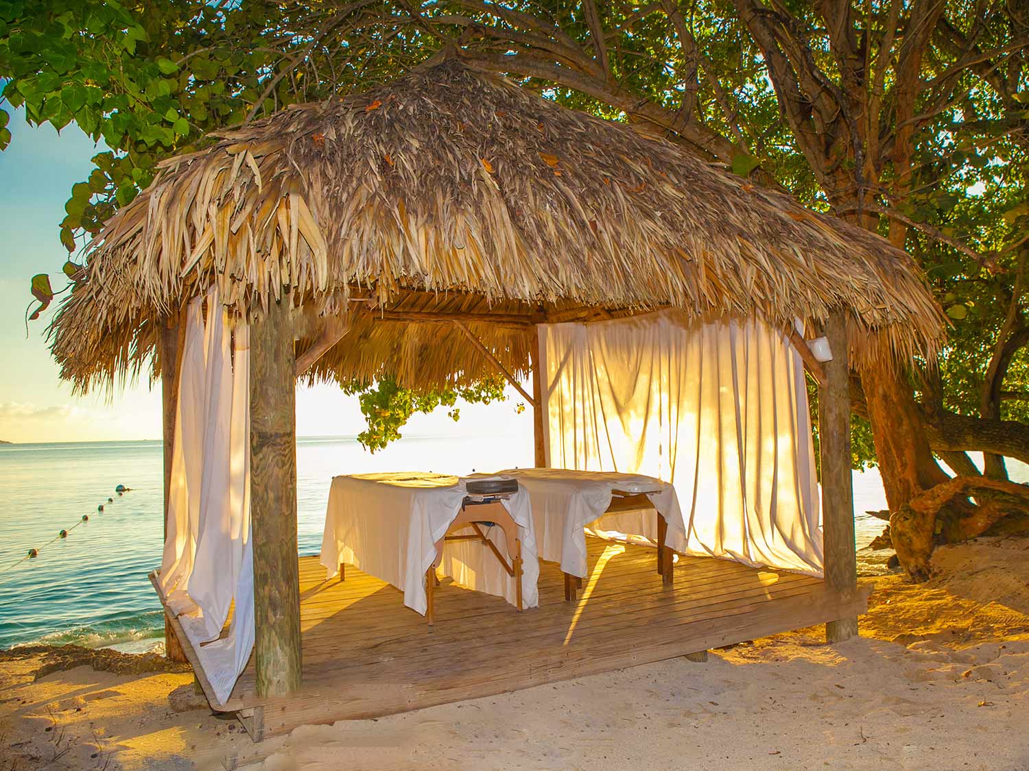Hedonism II offers many amenities just like ordinary resorts, including romantic couples massages right on the beach.
