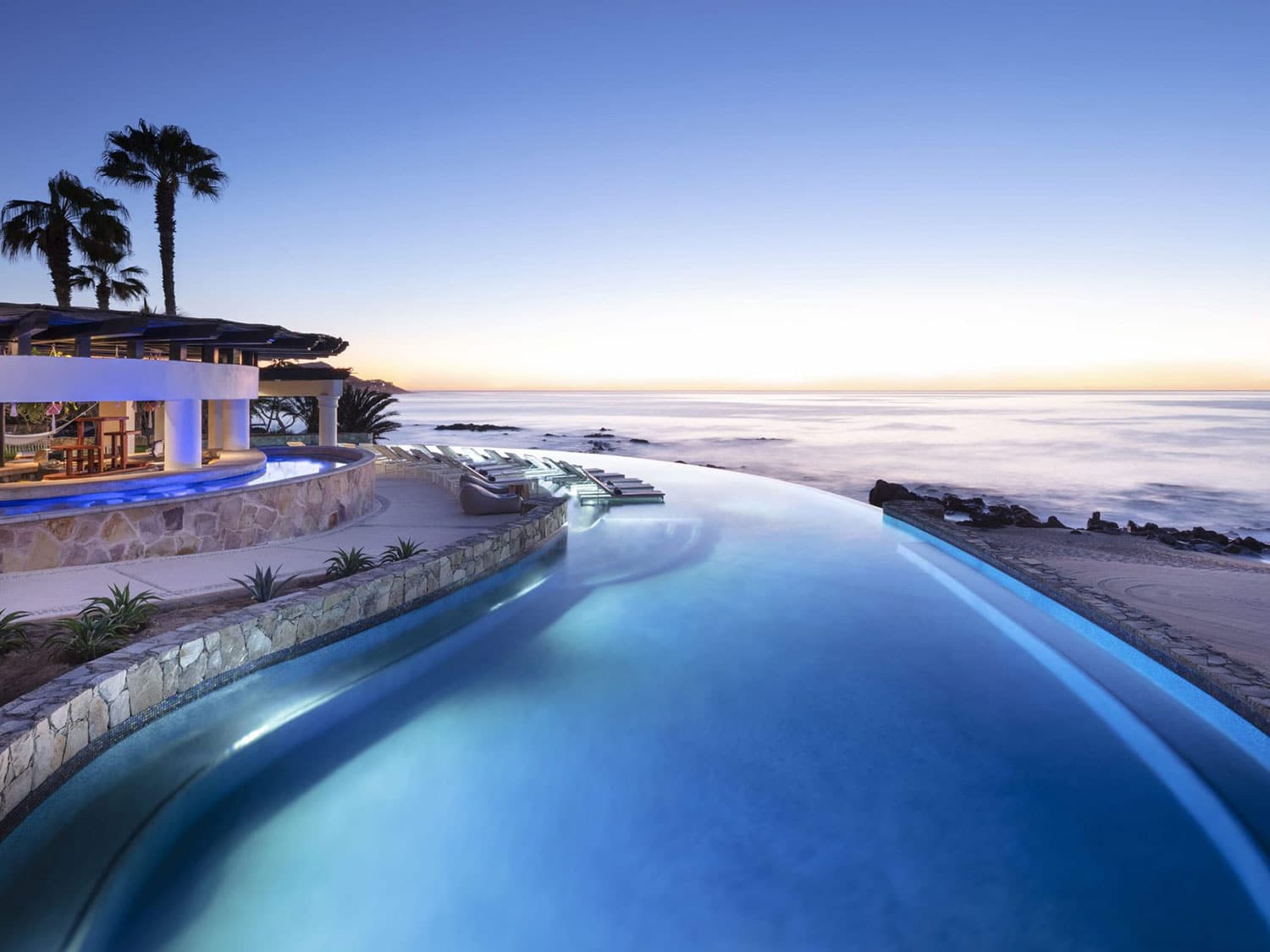 A luxury resort-style pool overlooking the ocean.