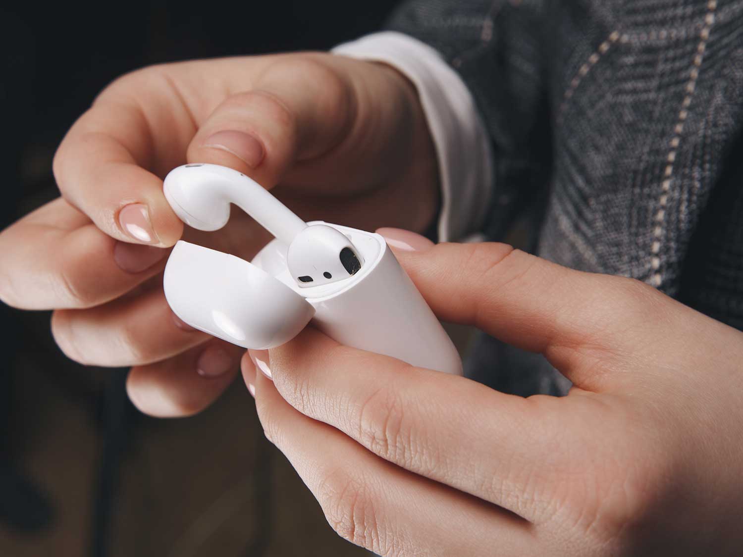 Person holding airpods