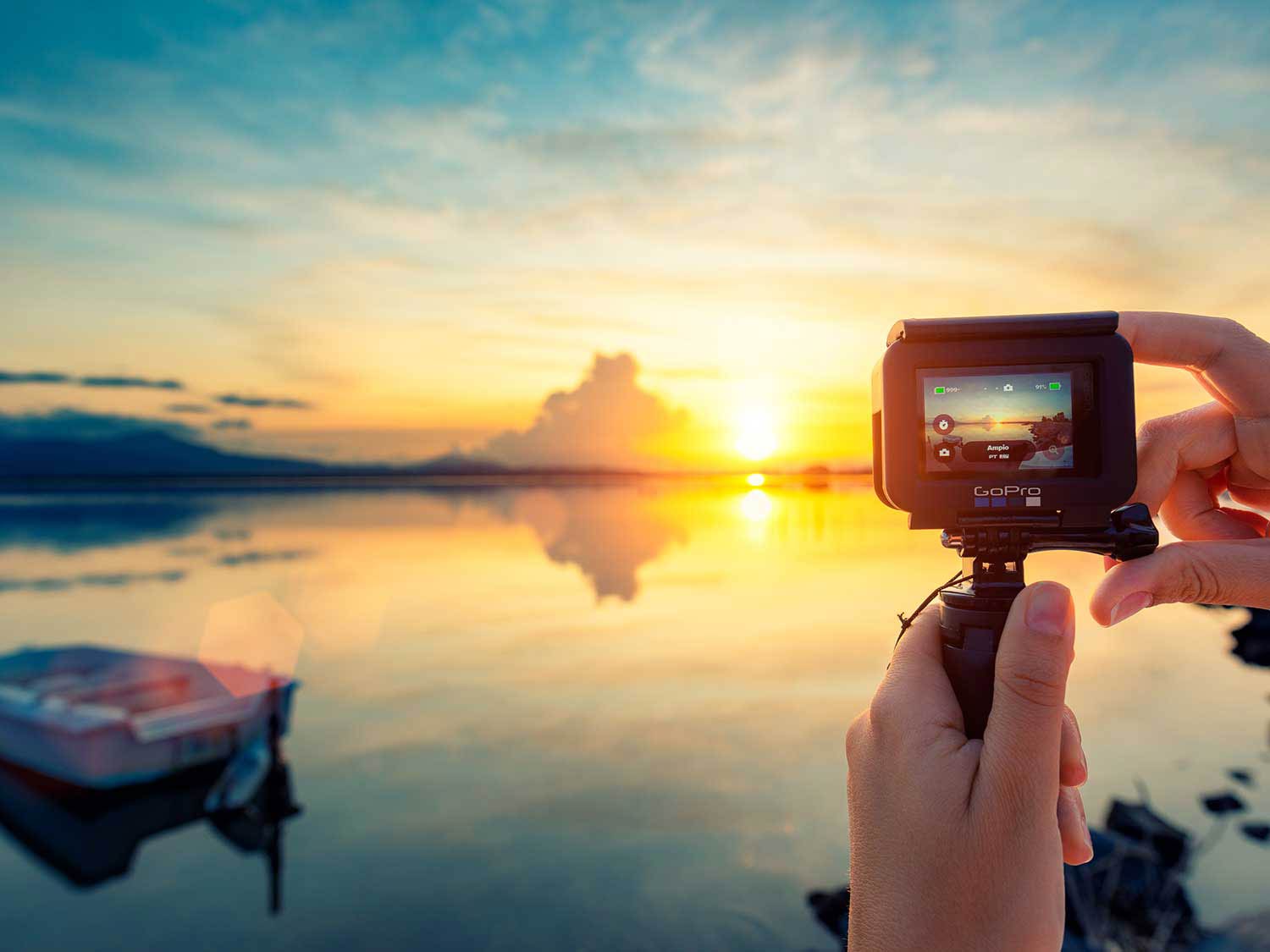 Person using a GoPro at sunset