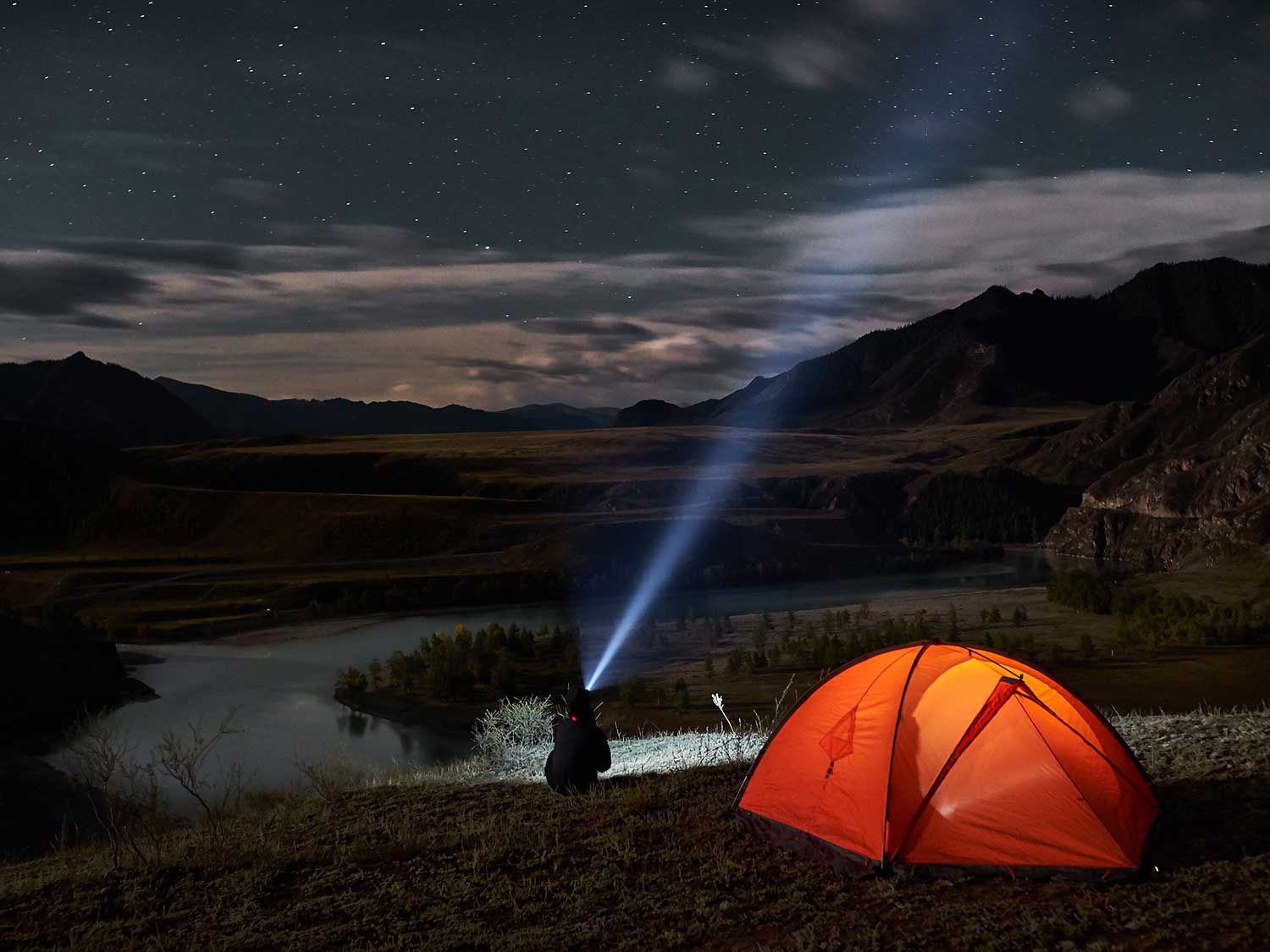 Camping at night with a flashlight