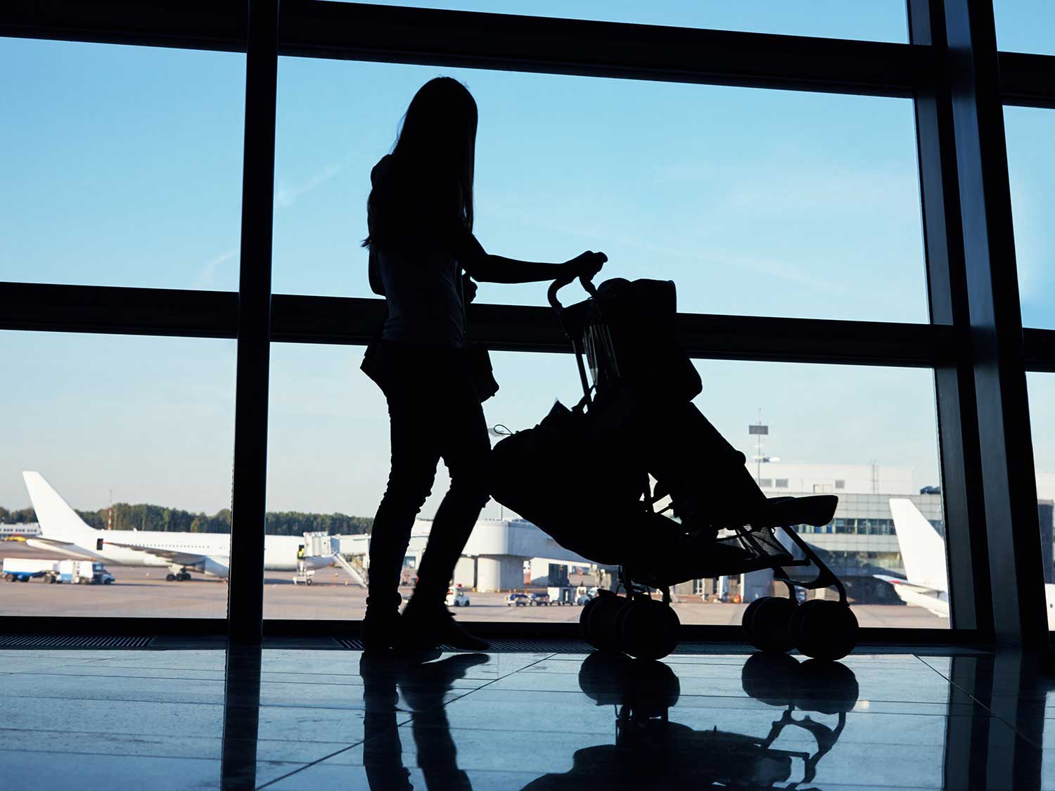 Woman pushing stroller through airport