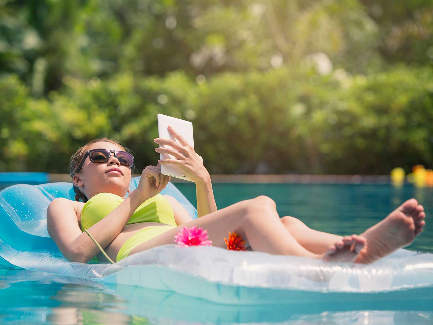 Woman lounging in the pool on a float