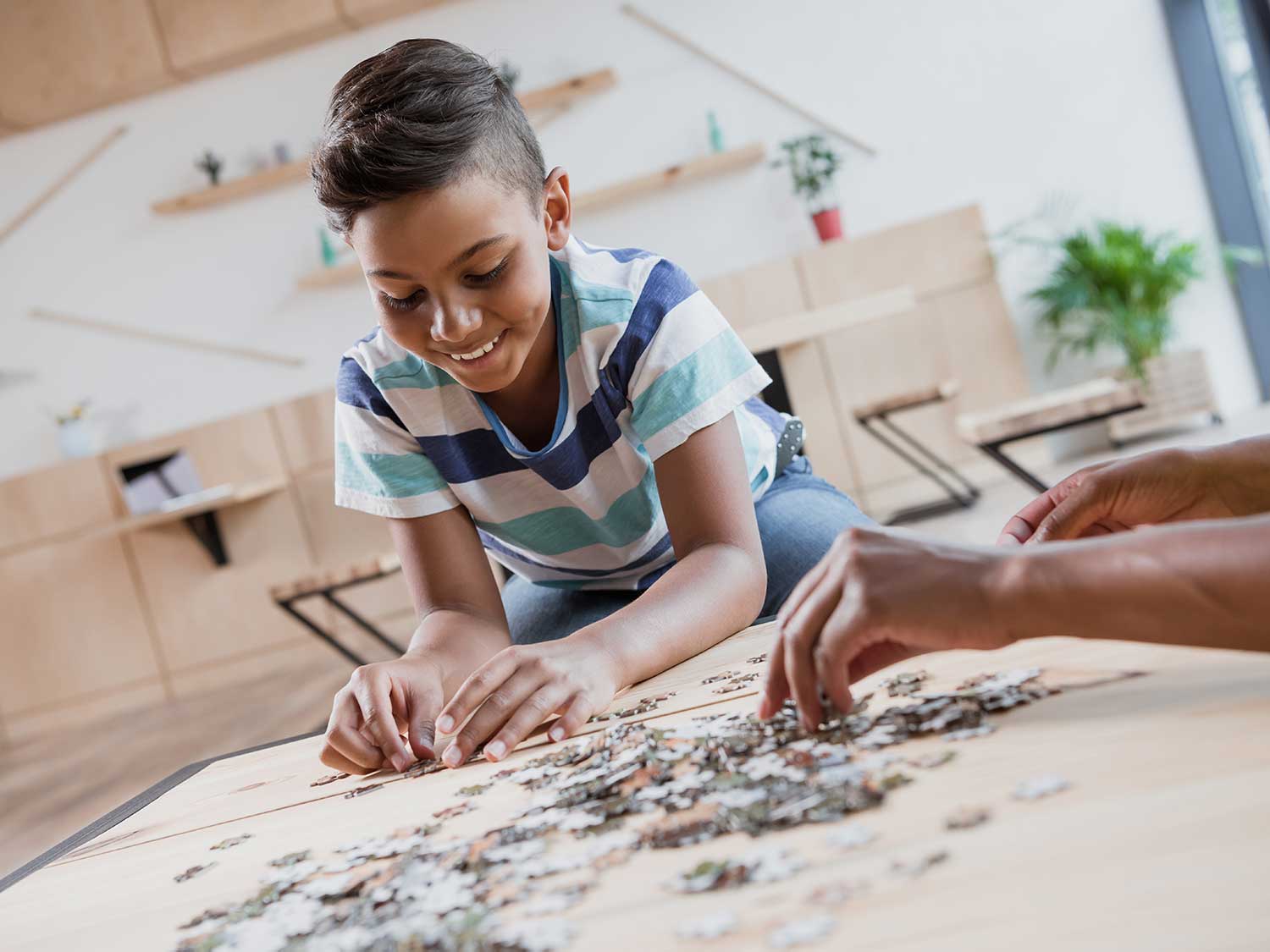 Little boy working on a puzzle