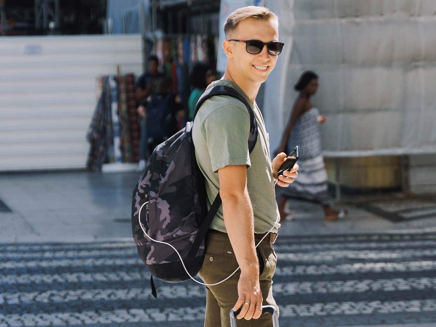 Smiling man wearing backpack