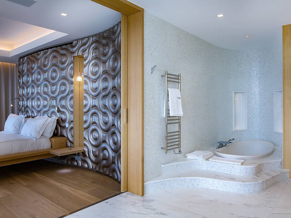 A modern bedroom and bathroom at Villa Neo