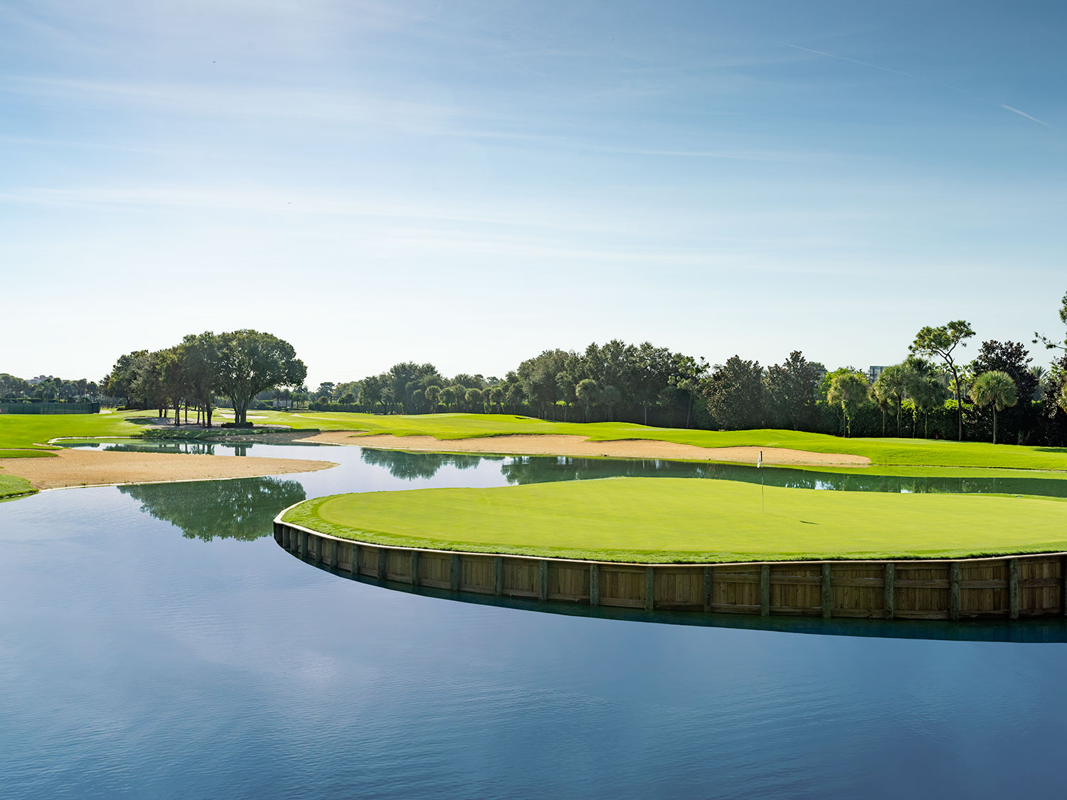 A lush, green golf course with a surrounding lake in Florida.