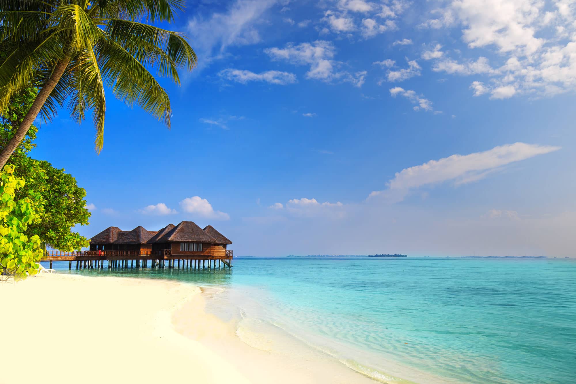 Overwater bungalows on a beautiful beach in Tahiti.