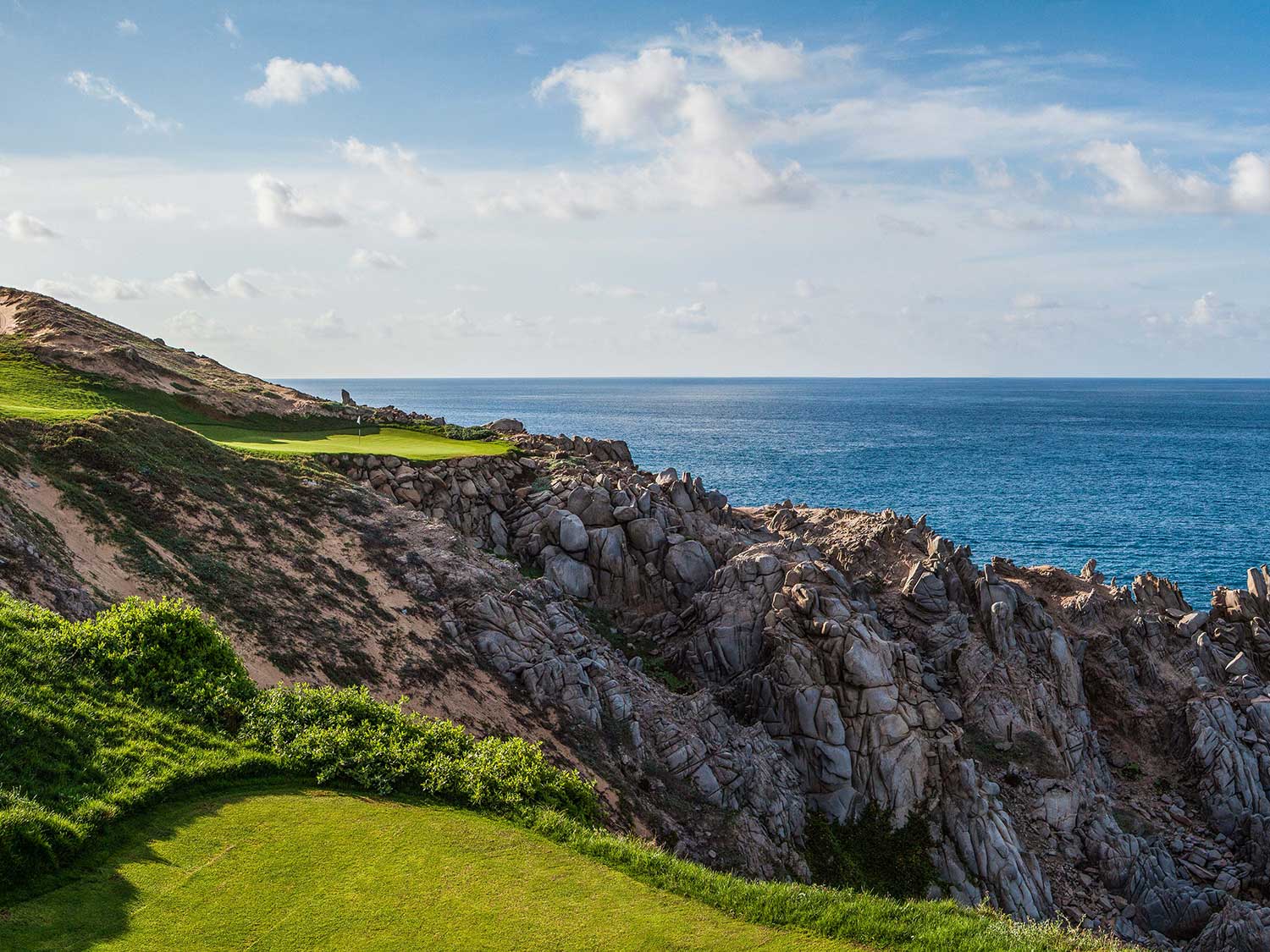 A rocky cliffside next to the Quivira Golf Club.